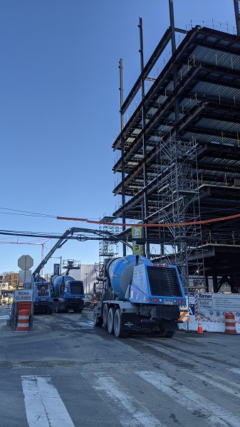 Cement trucks ready to start pouring concrete floors of the new building.